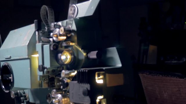 Opto-mechanical movie projector in operation.
