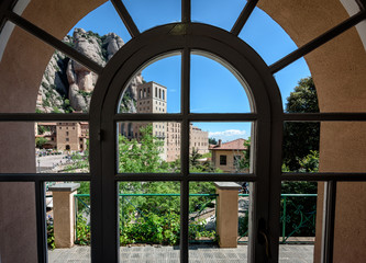 View on buildings of old Montserrat monastery through vintage window