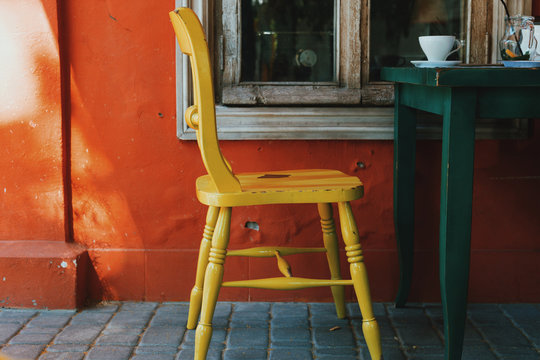 Yellow chair. Tolerance. View of terrace on the street