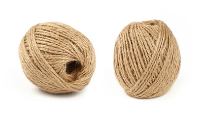 Two coil bobbins of burlap jute twine over white