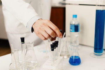 Test tubes in laboratory assistant's hands