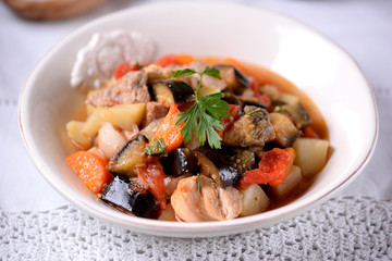 Pork stew with eggplant, tomato, onion, potatoes, carrots, garlic and parsley.