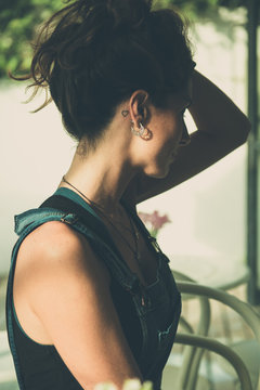 Young Woman At Coffee Shop Grabbing Her Hair And Showing Neck