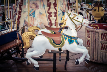 Fototapeta na wymiar White horse children's carousel