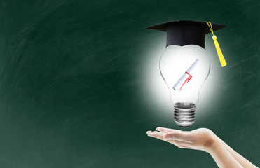 hand holding light bulb with certification for graduation shows the ingenuity intelligence knowledge and success for education on blackboard