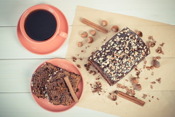 Vintage photo, Dark cake with chocolate, cocoa and plum jam, cup of coffee