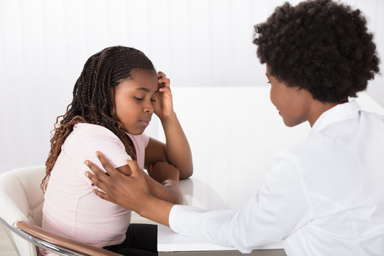 Female Doctor Comforting Depressed Patient