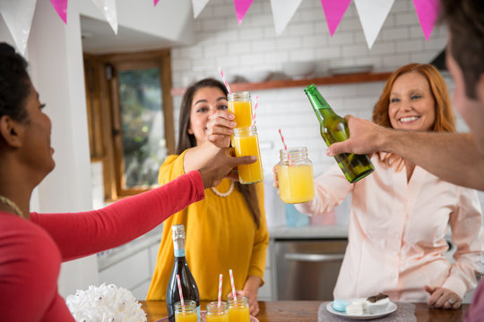 Family Gathering With Friends, People Cheers Their Beverage Drinks Celebrating At A House Home Party