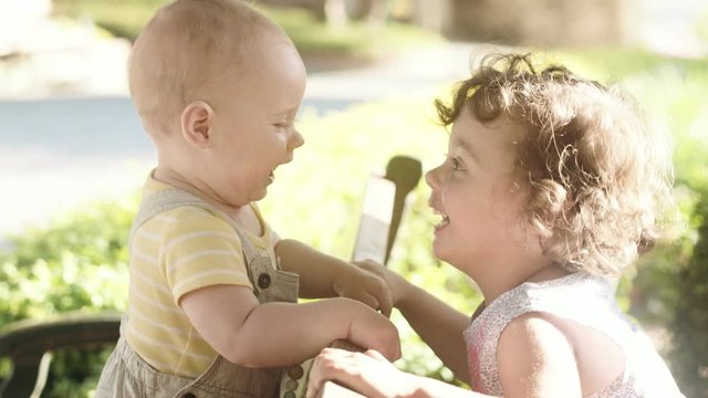 Cute little girl kissing her small brother
