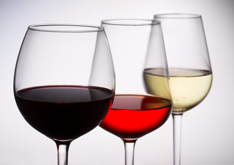 Set of three wine glasses with red, white and rose wine close up