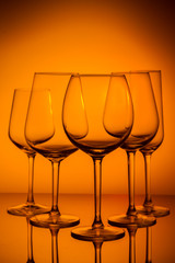 Set of wine glasses on orange background