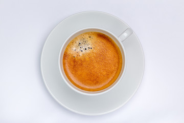 Fototapeta premium Hot black coffee with foam bubbles in white cup with white background, morning coffee concept.