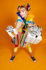 Girl clown. Girl gives gifts. Children holidays.