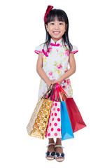 Asian Chinese little girl wearing cheongsam holding shopping bags