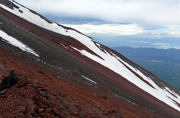 Steep Terrain on climbing route during storm on Mount Fuji, a symmetrical volcano and tallest peak...
