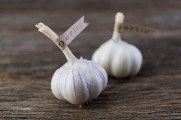 Decorated garlic bulb on vintage wood background