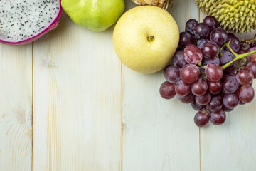 Set of different fruits on wooden table with copy space