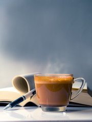 A cup of Cappuccino coffee with natural smoke on rustic background, copy space