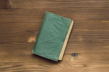 Close vintage book on the wooden table. Education or reading concept.