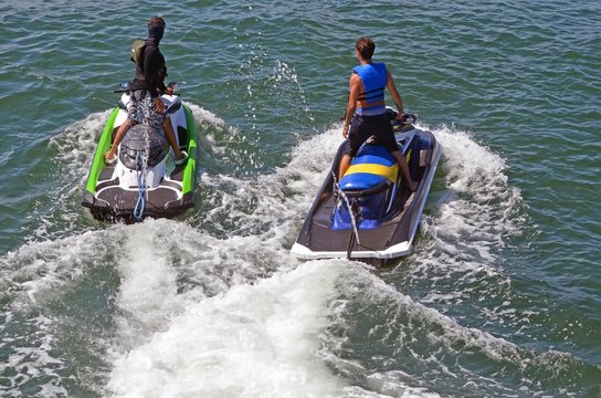 Angled Overhead View Of Two Jet Skiers Slowly Cruising On The Florida Intra-coastal Waterway Near   Miami Beach.