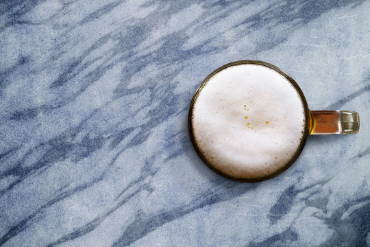 Glass of beer on marble abstract tie table, Top view