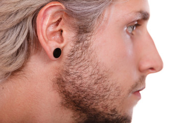 Teen boy with piercing and fashionable hairstyle