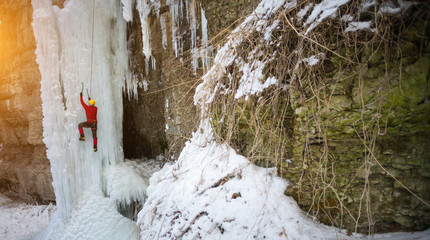 The climber climbs on ice.