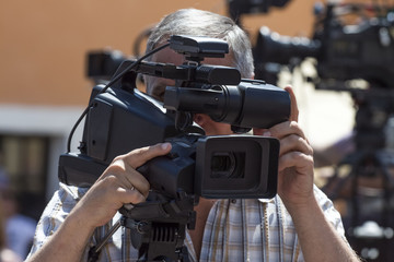 The man is shooting a reportage photo