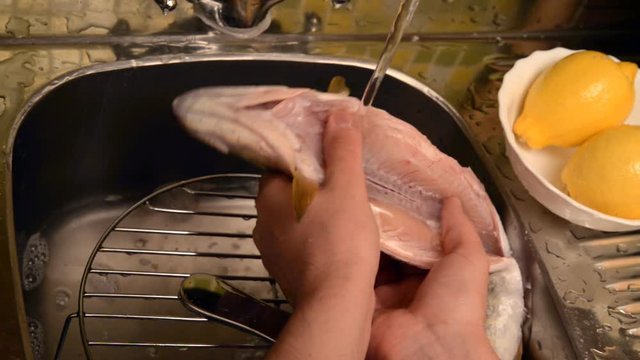 Washing and cleaning of fish.