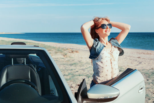 Relaxing woman on the beach in the car