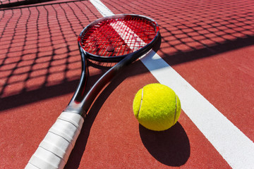 Tennis balls and racket on the grass court