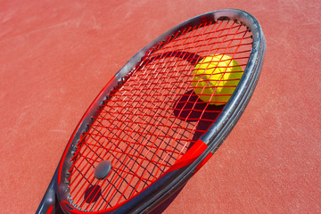 Tennis balls and racket on the grass court