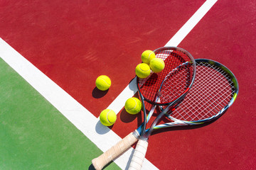 Tennis balls and racket on the grass court