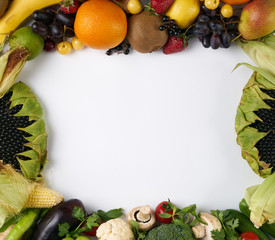 Top view of a variety of fresh summer fruit and vegetables - apples, peaches, tomatoes , eggplants, oranges, grapes,  and other useful nutrients. Copy space for your text.