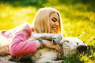 Woman is relaxing with dog