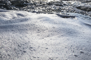 Fototapeta na wymiar Foam on the water - selective focus