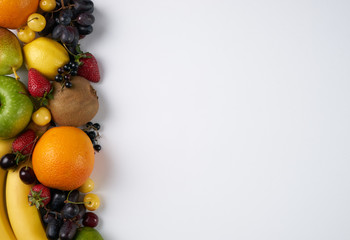 Top view of a huge group of fresh vegetables and fruit on white background with copy space. Vegetables VS Fruit - High quality studio shot