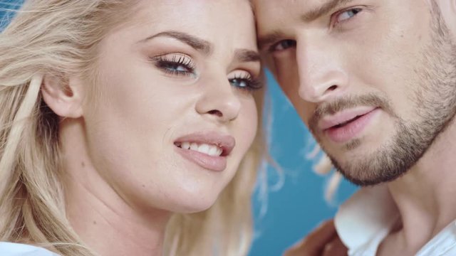 Sexy young couple posing on studio background, 4k slow motion studio clip