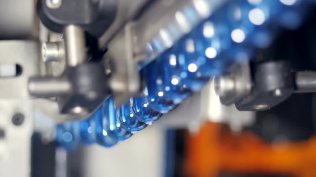 Close up view of one row of water bottle preforms. 