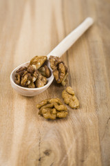 Walnuts in a spoon on a wooden table
