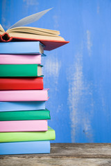 Stack of books on a blue background.