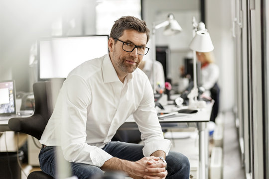 Portrait of businessman at desk in office