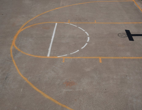 View of a part of a basketball court from above with shadow of the net