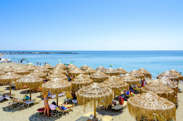 Beach with sunbeds an umbrelas  in Skiros island, Sporades, Greece