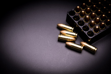 9 mm full metal jacket bullet on black background