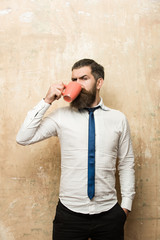 hipster with serious face drink tea from coffee cup