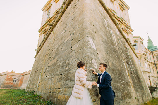 The newlyweds spanding their honeymoon near the old gothic castle.
