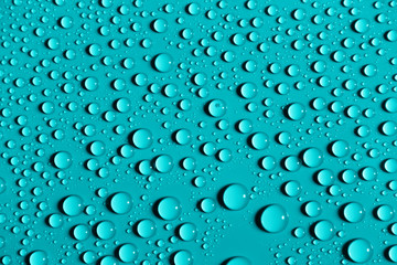 Water drops on a smooth surface, azure background