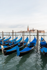 Row of gondolas in Venice laguna, Italy