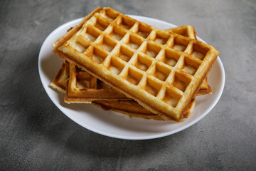 Freshly baked belgium waffles in plate